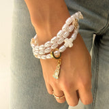 Pulsera rosario de perlas imitación agua con cruz blanca y dije esmaltado de la Virgen de Fátima