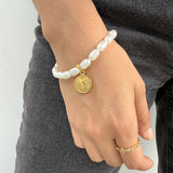 Pulsera de Imitación Perla de Agua con Medalla del Ángel de la Guarda – VII Sacramentos Colombia