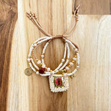 Pulsera Escapulario Beish con Mostacillas y Dijes de Fé - VII Sacramentos Colombia